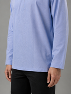 Lower front view of men's light blue short tunic shirt showing straight bottom hem and sleeve fit.