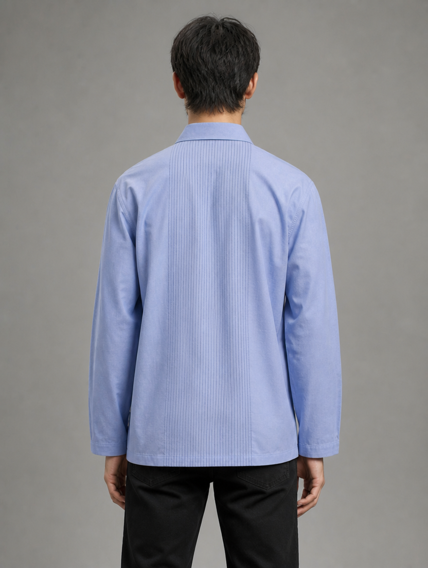 Back view of men's light blue short kurta shirt showing vertical center pleats and relaxed tailoring.