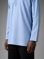 Lower front view of men's light blue short kurta showing straight hemline and long sleeves.