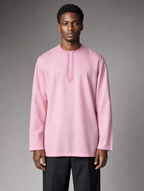 Urban Crescent light pink men's short kurta featuring a embroidered round neck and long sleeves with black trousers.